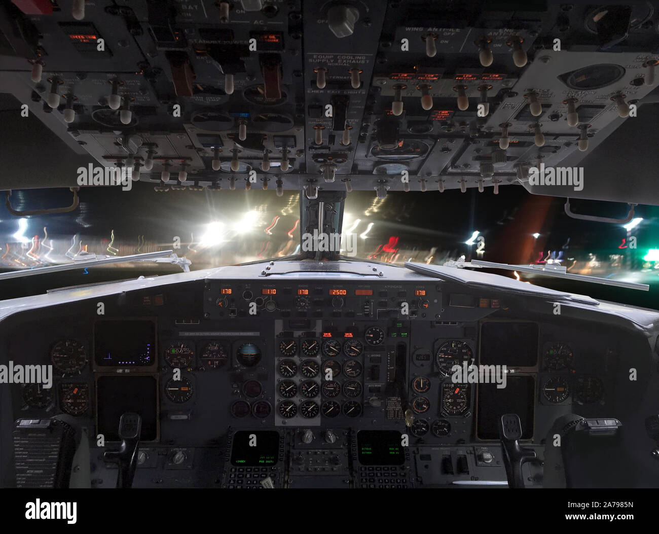 View from pilot cockpit from lended airplane to airfield and airport  infrastructure at night Stock Photo - Alamy