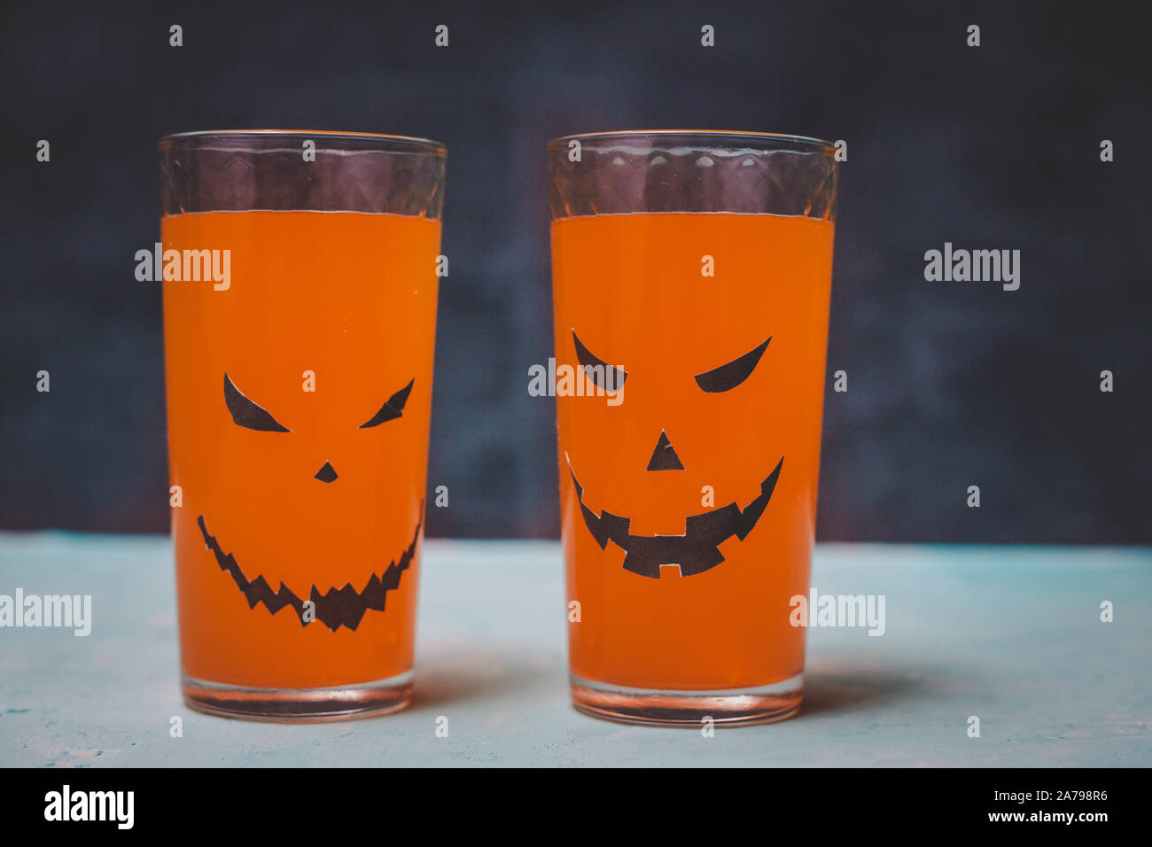 glasses with spooky pumpkins and cookies for Halloween Stock Photo