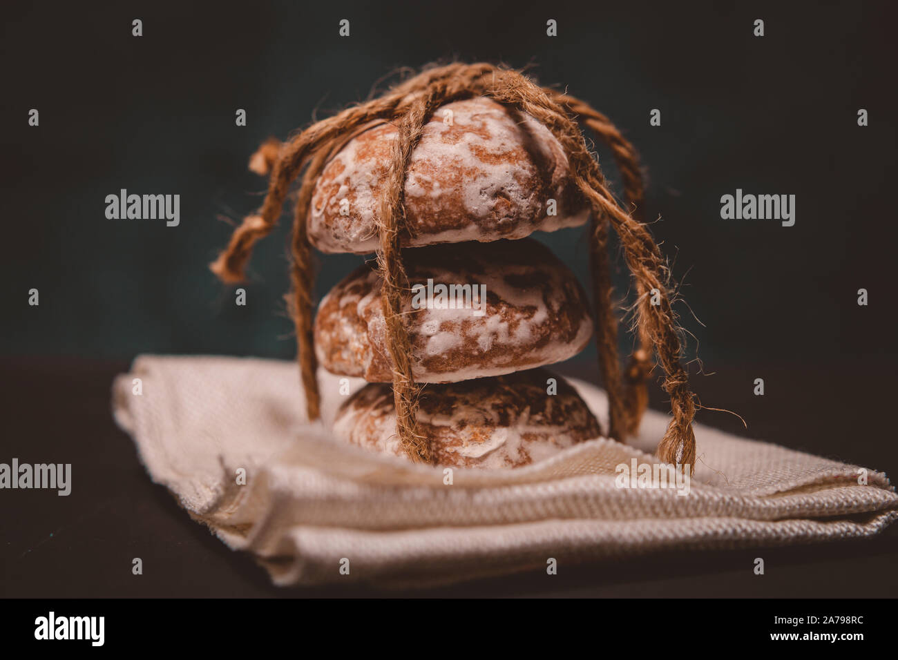 fresh gingerbread cookies tied with a rope on the table Stock Photo