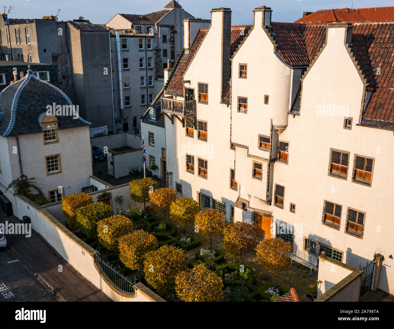 Leith, Edinburgh, Scotland, United Kingdom, 31st October 2019. UK Weather: Autumn colours in the box trees and low light as the sun goes down at Lamb's House, a restored 17th century Hanseatic Merchant's House with distinctive Dutch-style stepped gables and original 'wind doors', part of which is now the Icelandic Consulate Stock Photo