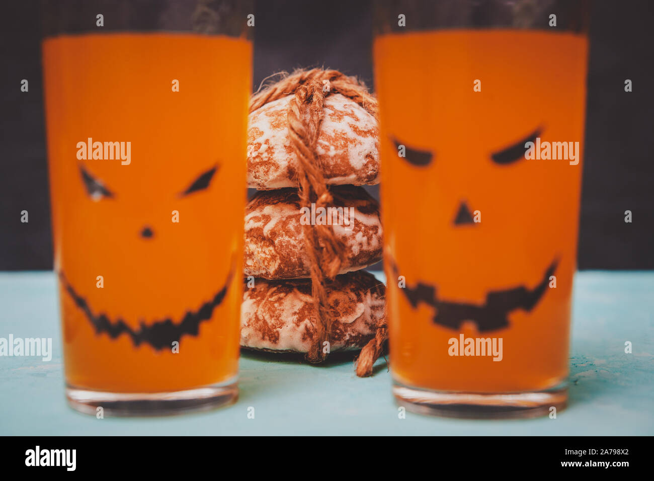 glasses with spooky pumpkins and cookies for Halloween Stock Photo