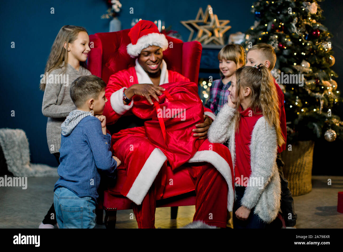 African Santa Claus Sitting In Armchair And Giving The Presents To