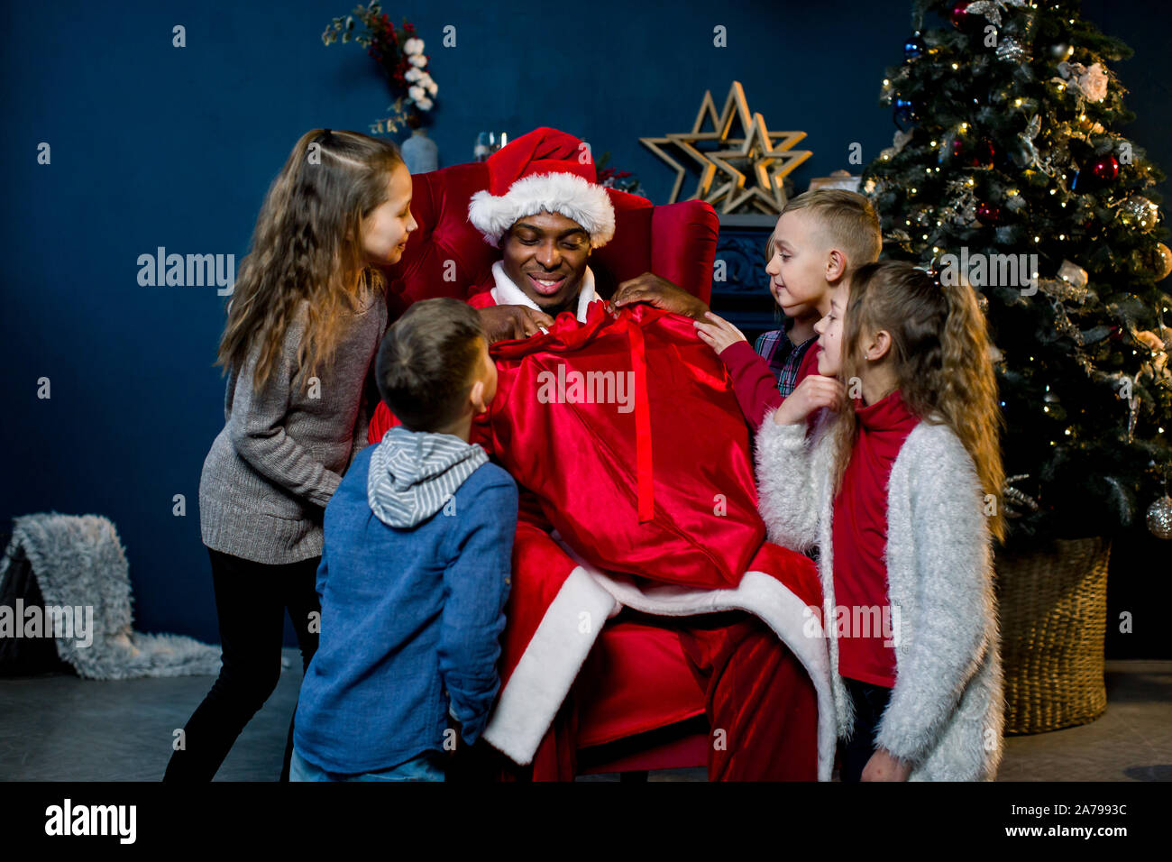 African Santa Claus Is Seated And Gives Presents To Beautiful