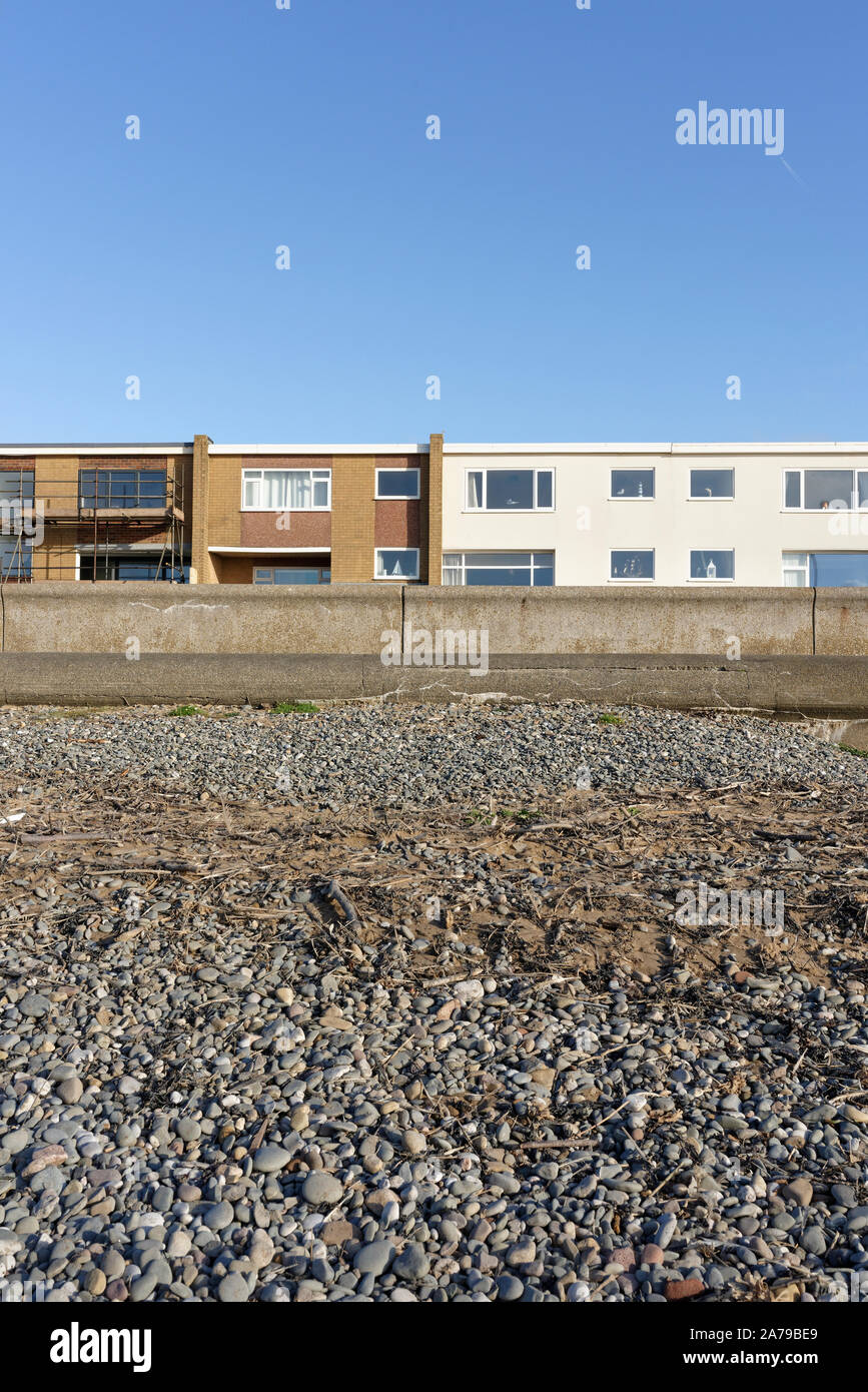 Beach and concrete seawall protecting houses on seafront in rossall on