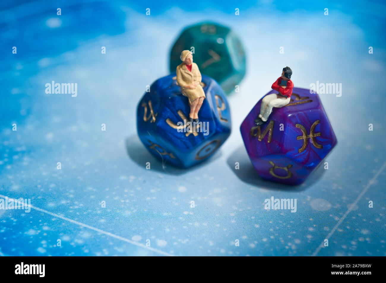 miniature figurines and esoteric dice, fortune telling concept Stock
