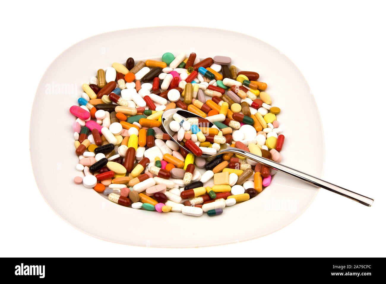 Verschiedene bunte Tabletten auf einem Teller angerichtet als Mittagessen, Symbolbilder Stock Photo