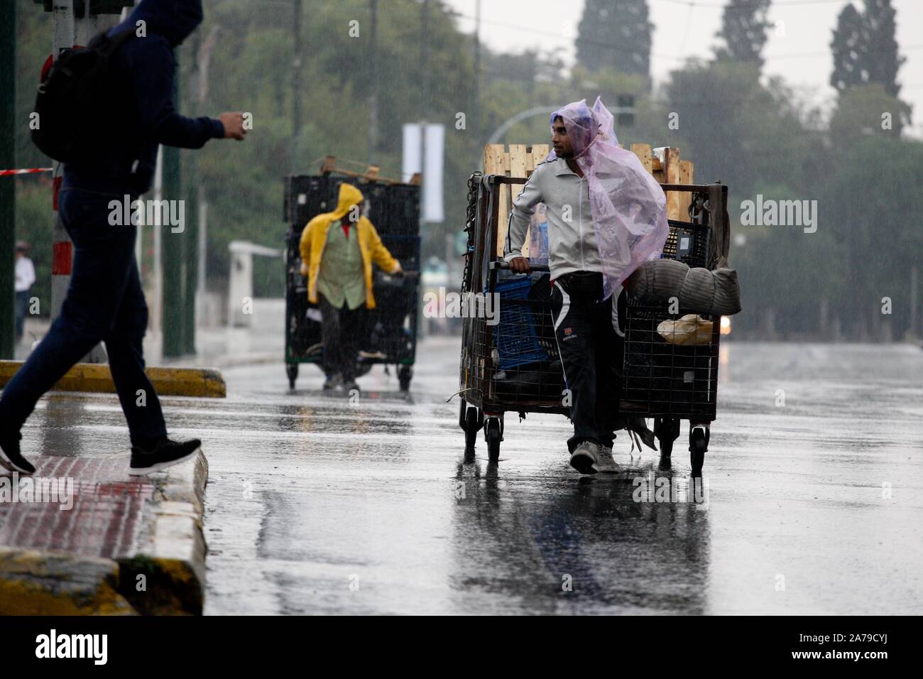October 31, 2019, Athens, Greece: Men with cart collecting cardboard and rubbish on streets into the rain in the center of Athens. (Credit Image: © Aristidis VafeiadakisZUMA Wire) Stock Photo