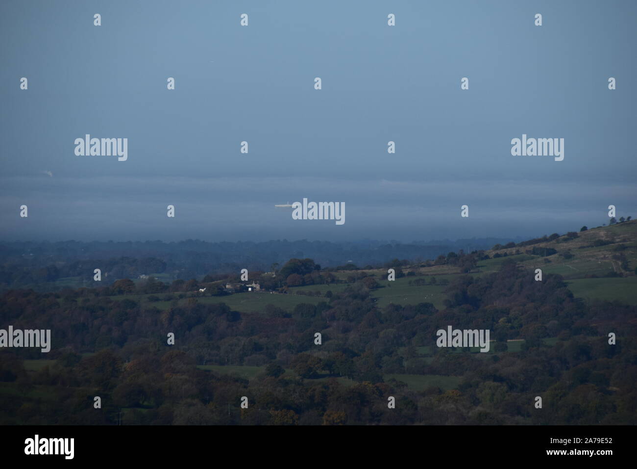The dish of the Jodrell Bank telescope 'floating' in the distant clouds. Stock Photo