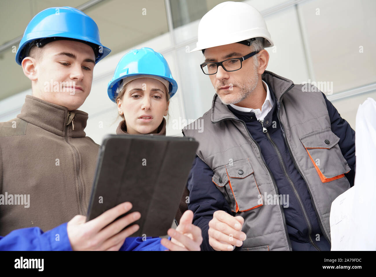 Instructor with young people in engineering training Stock Photo