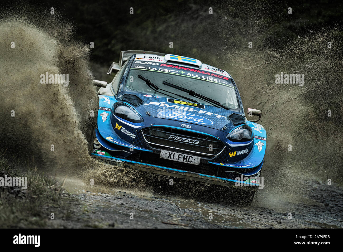 Pontus Tidemand driving his Ford Fiesta through a waterslash for the M-Sport Ford Performance World Rally Team at the 2019 WRC Wales  Rally GB, Wales Stock Photo