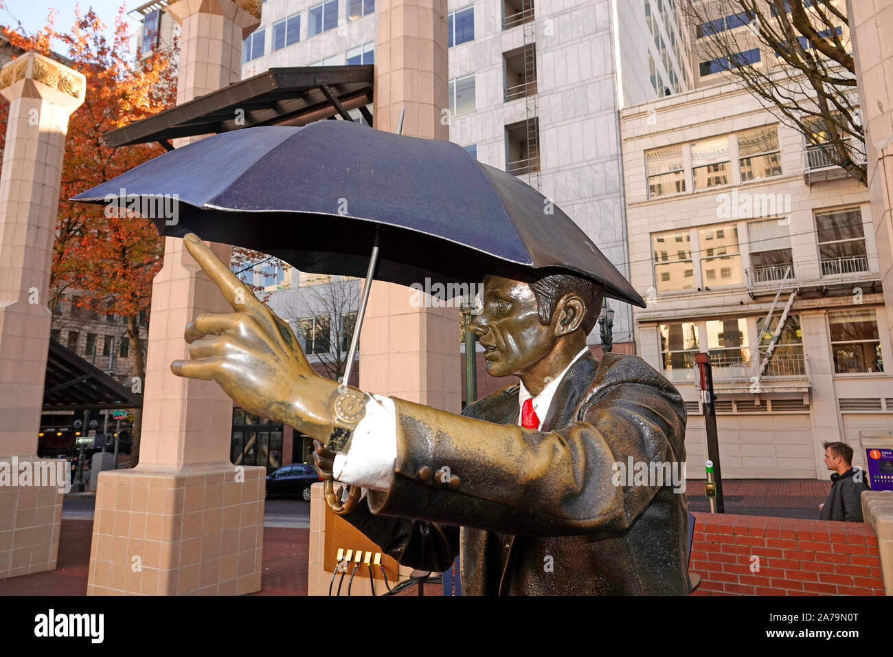 This sculpture, named 'Allow Me' but also called 'The Umbrella Man', is one of the main attractions for visitors to historic Pioneer Courthouse Square Stock Photo