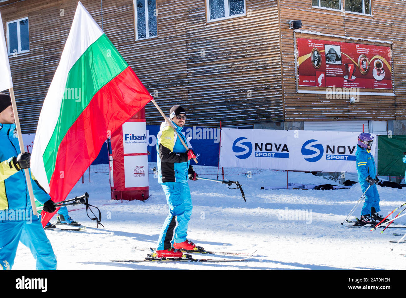 Bansko, Bulgaria - December, 12, 2015: Opening new ski season 2015-2016 in Bansko, Bulgaria. Skiers with Bulgarian flag at the slope Stock Photo