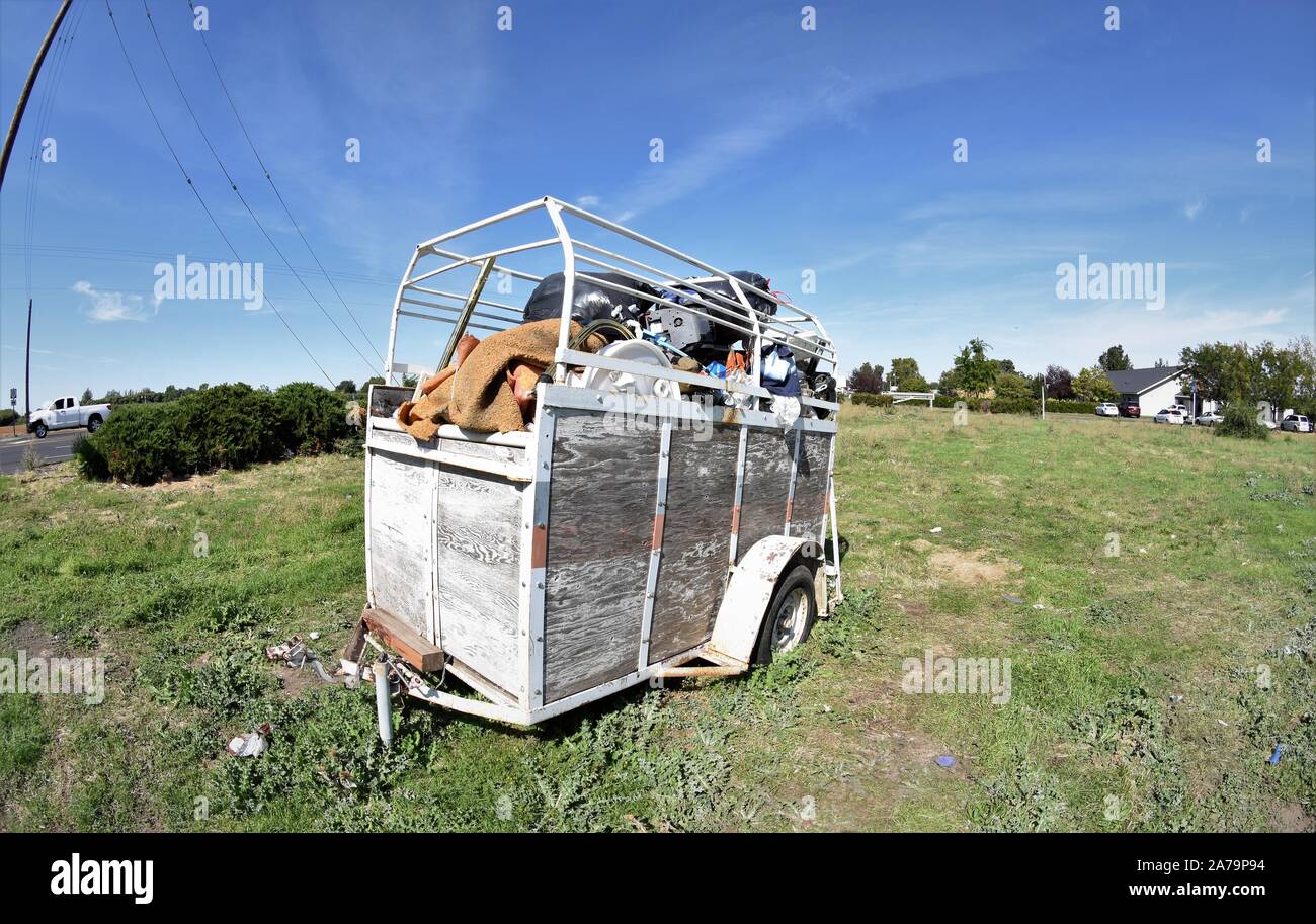 Trailer full of trash left on side of a road in Washington USA America Stock Photo