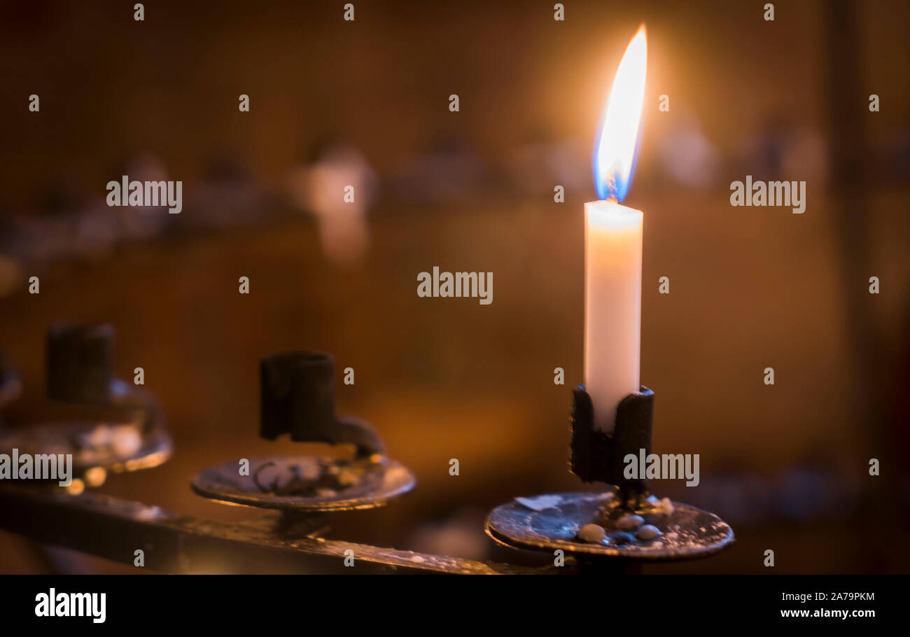 candle in the church, praying with faith, traditional visit of a holy place for Easter, great Christian holiday, belief in God concept. Stock Photo