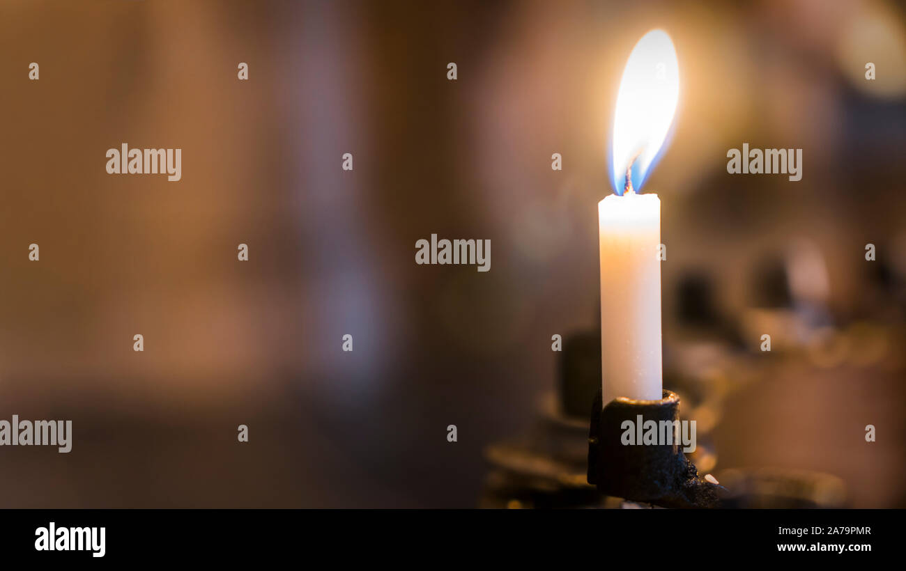 candle in the church, praying with faith, traditional visit of a holy place for Easter, great Christian holiday, belief in God concept. Stock Photo