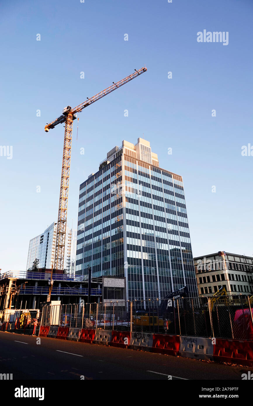 A giant building crane works on a new office building in downtown Portland, Oregon Stock Photo