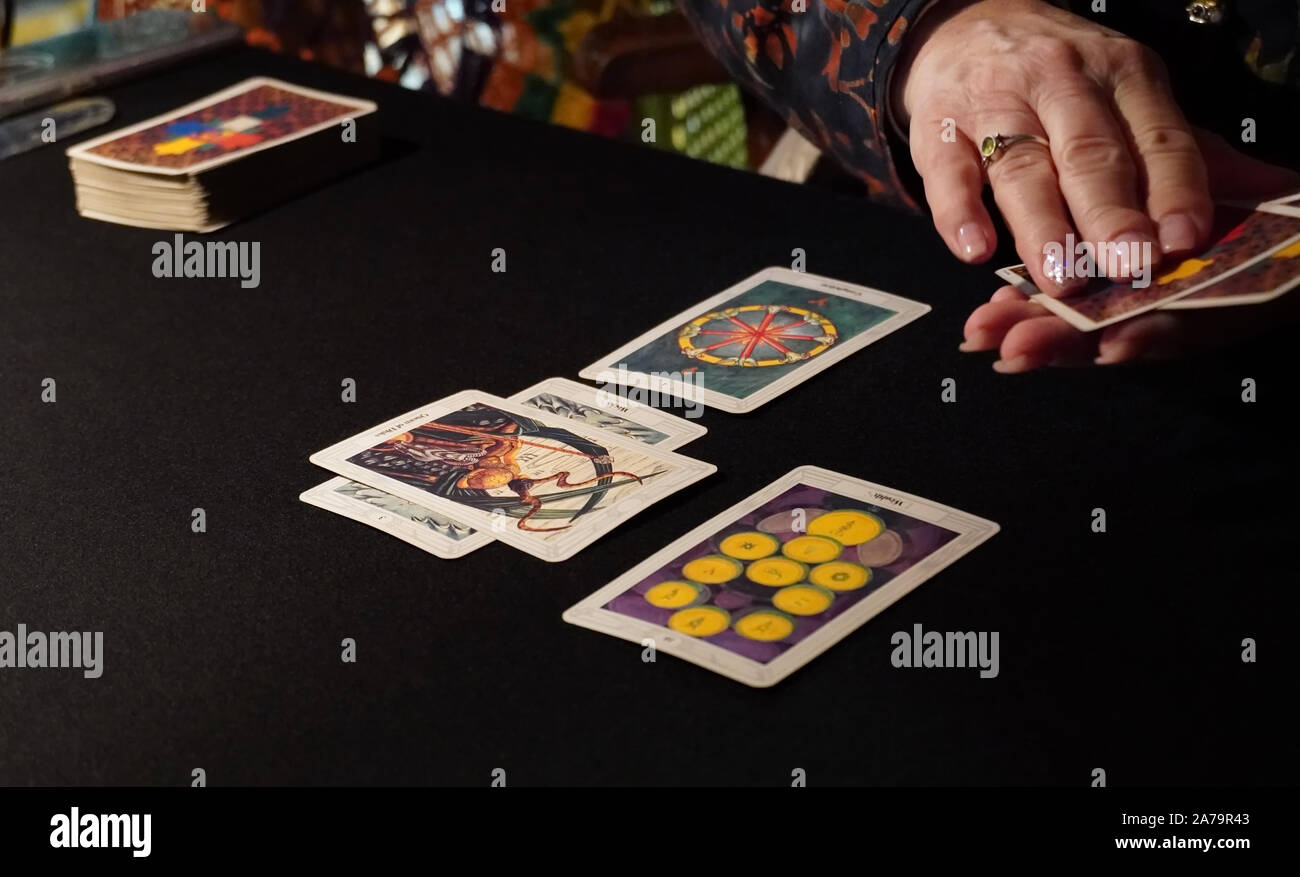 Boothbay Harbor, ME / USA - October 20, 2019: Tarot card reader arranges cards in a 6 card spread Stock Photo