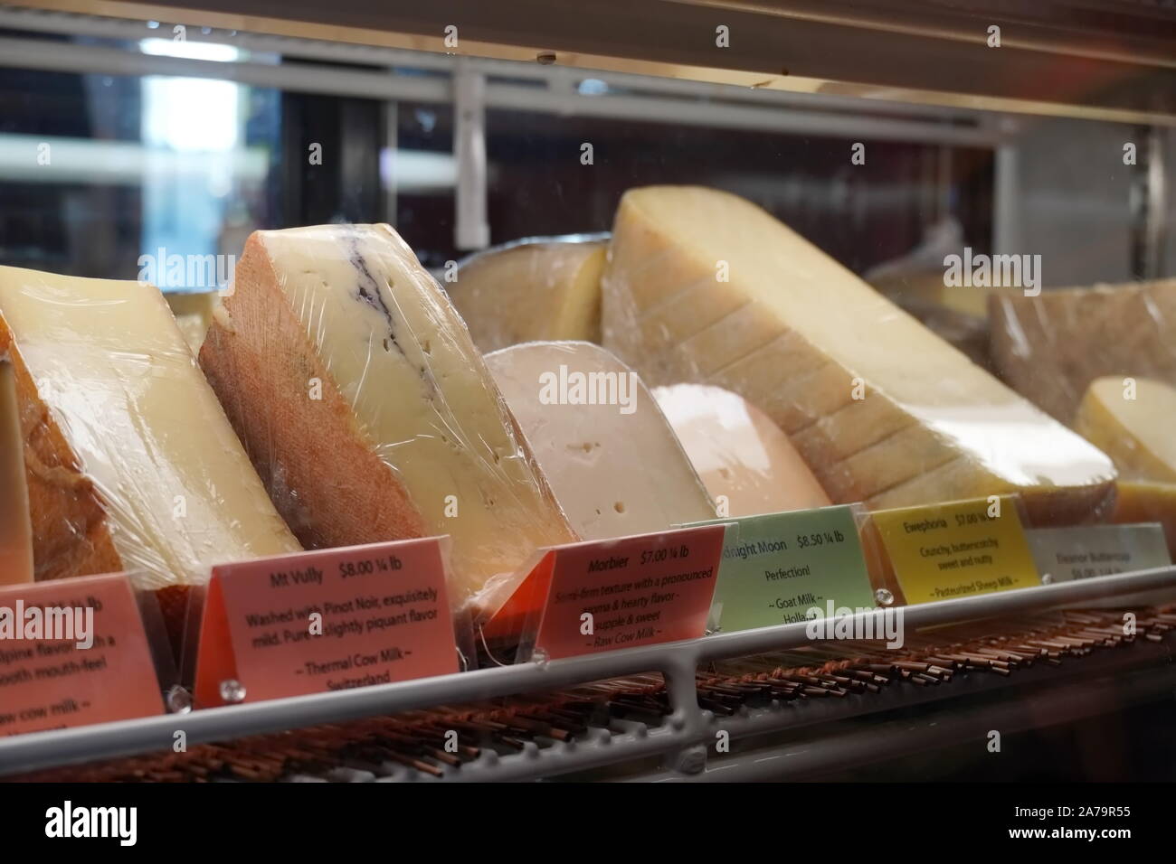 Boothbay Harbor, ME / USA - October 20, 2019: Various gourmet cheeses behind a glass display at Eventide Specialties Stock Photo