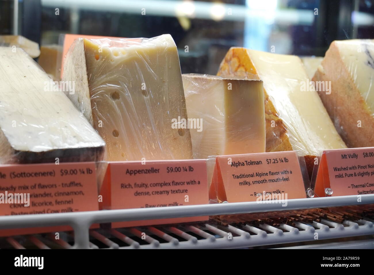 Boothbay Harbor, ME / USA - October 20, 2019: Various gourmet cheeses behind a glass display at Eventide Specialties Stock Photo