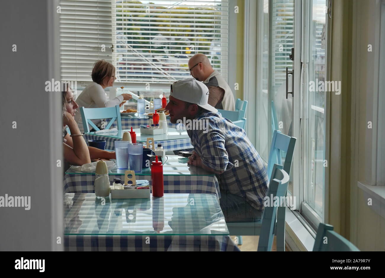 Boothbay Harbor, ME / USA - October 19, 2019: Young adult and middle aged caucasian couples eating brunch at a local restaurant Stock Photo