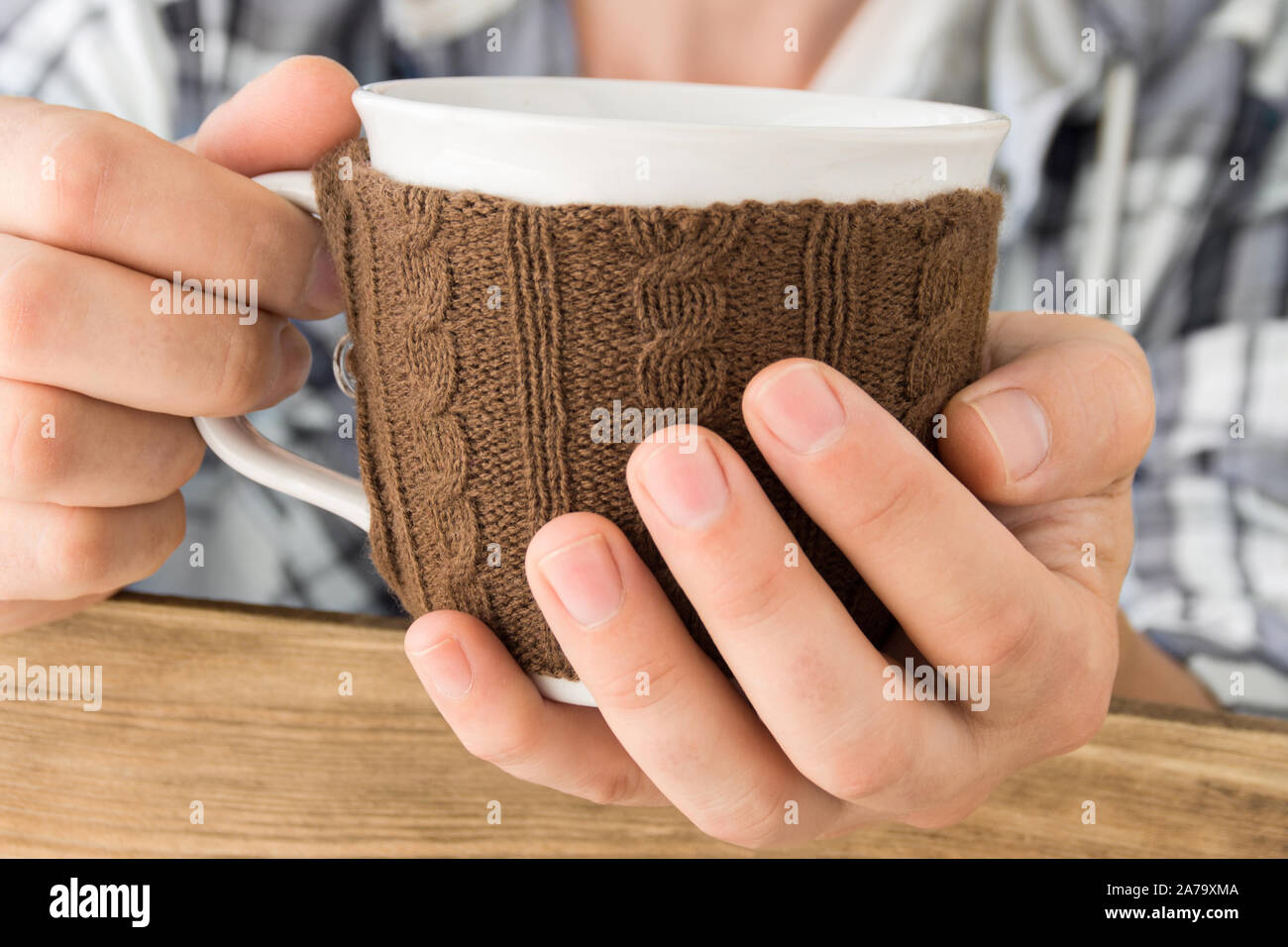 Cup warmer in male hand Stock Photo