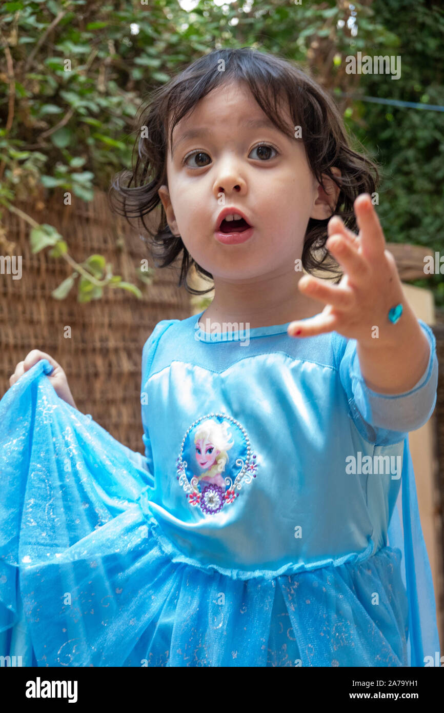 3-4 year old girl in Elsa princess dress gesturing Stock Photo