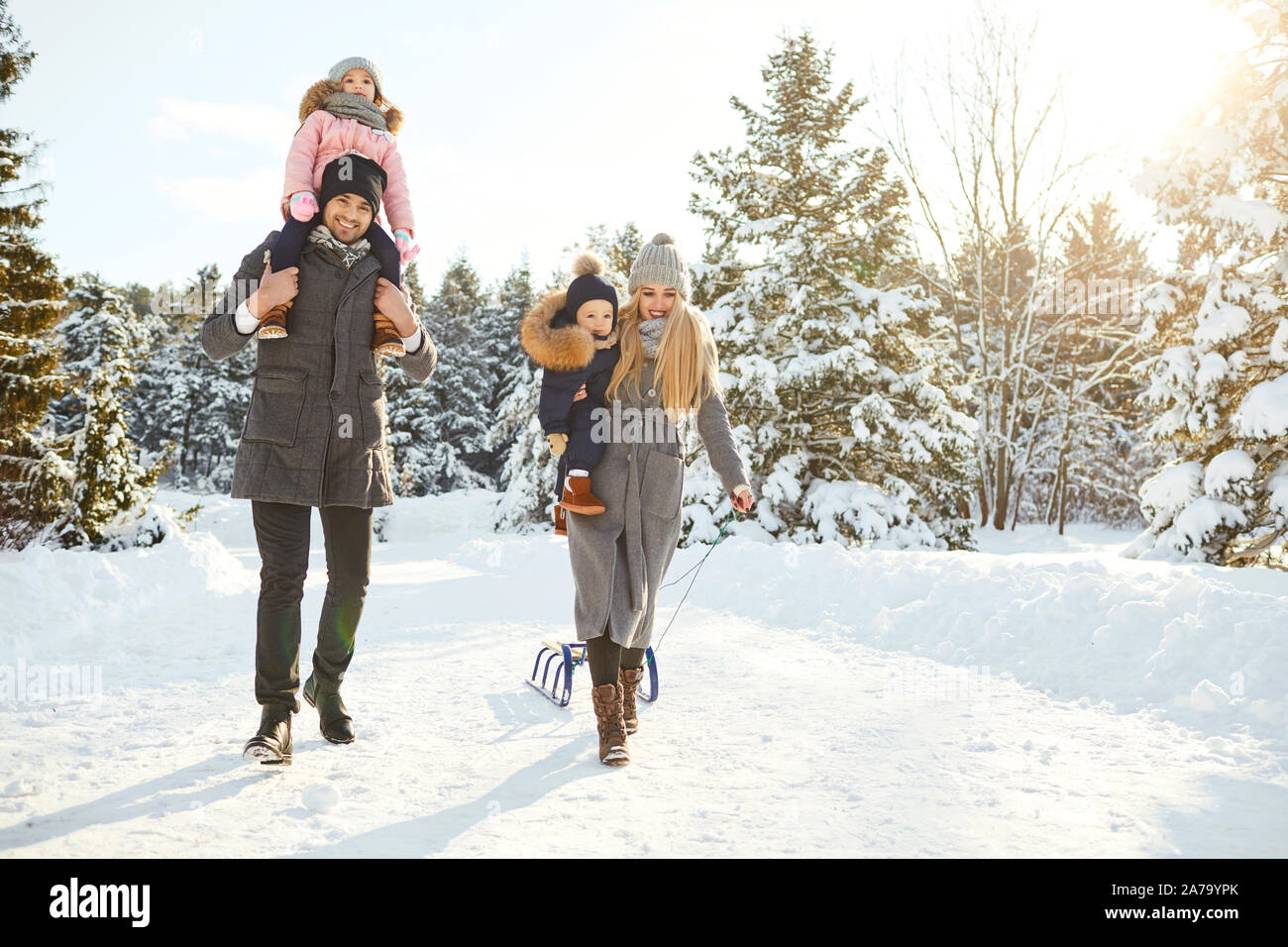 Happy family sledding in the park in winter Stock Photo - Alamy