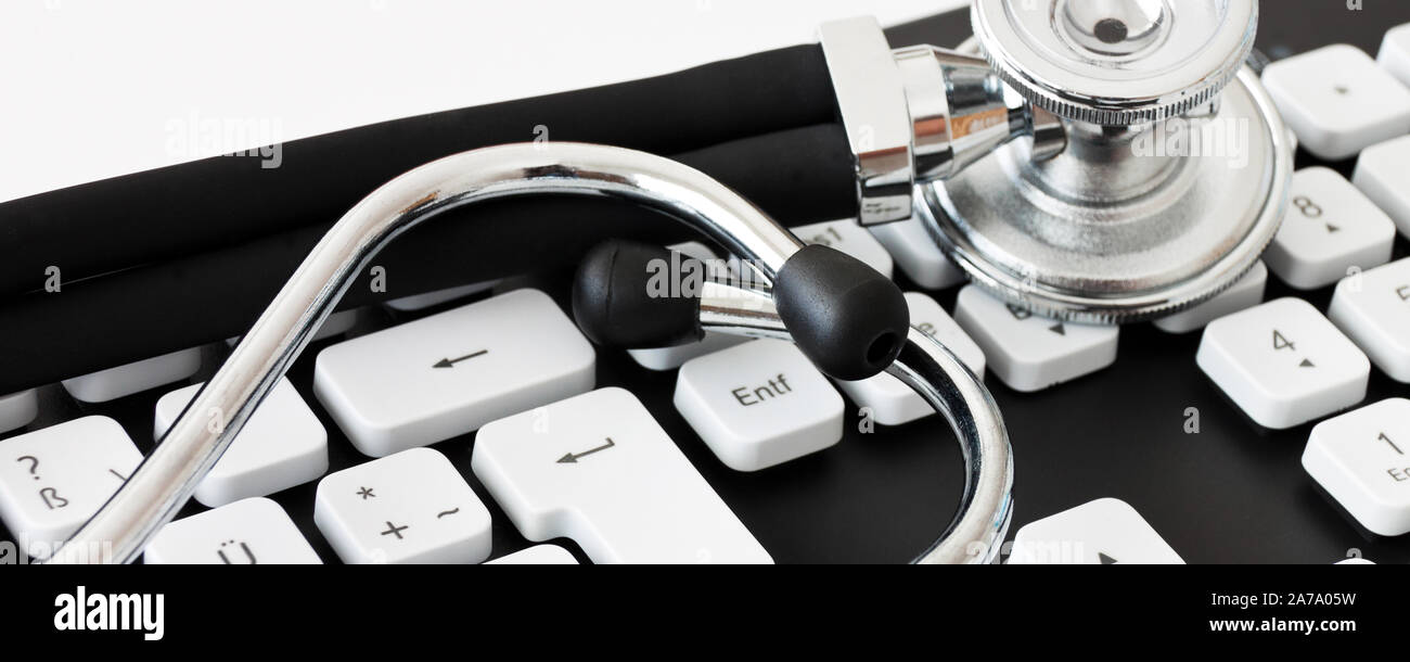 Keyboard with stehoscope on white background close up view Stock Photo