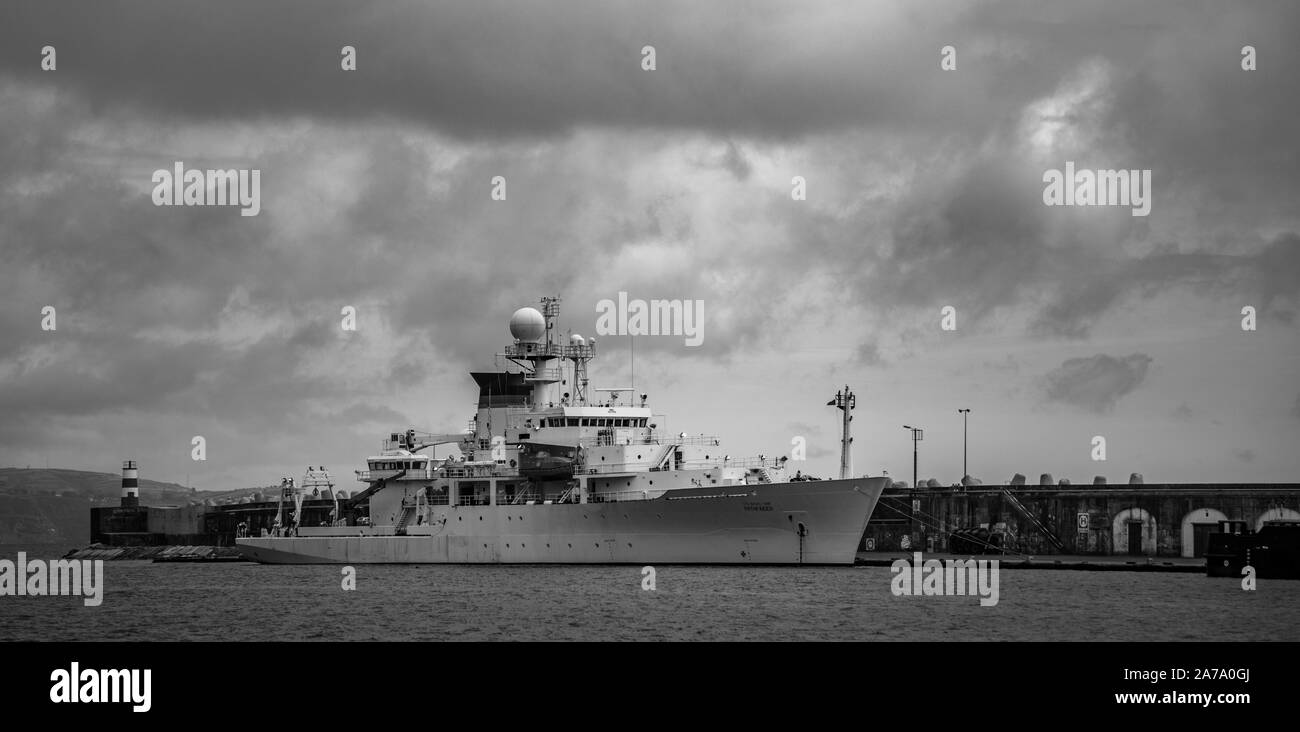 A black and white picture of a battleship docked in the Ponta Delgada Port. Stock Photo