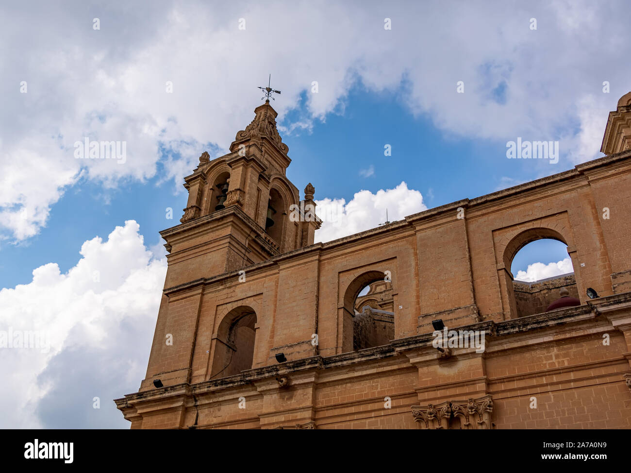 St Paul's Cathedral bell tower shot from low angle against blue cloudy sky, in Mdina, Malta. Stock Photo