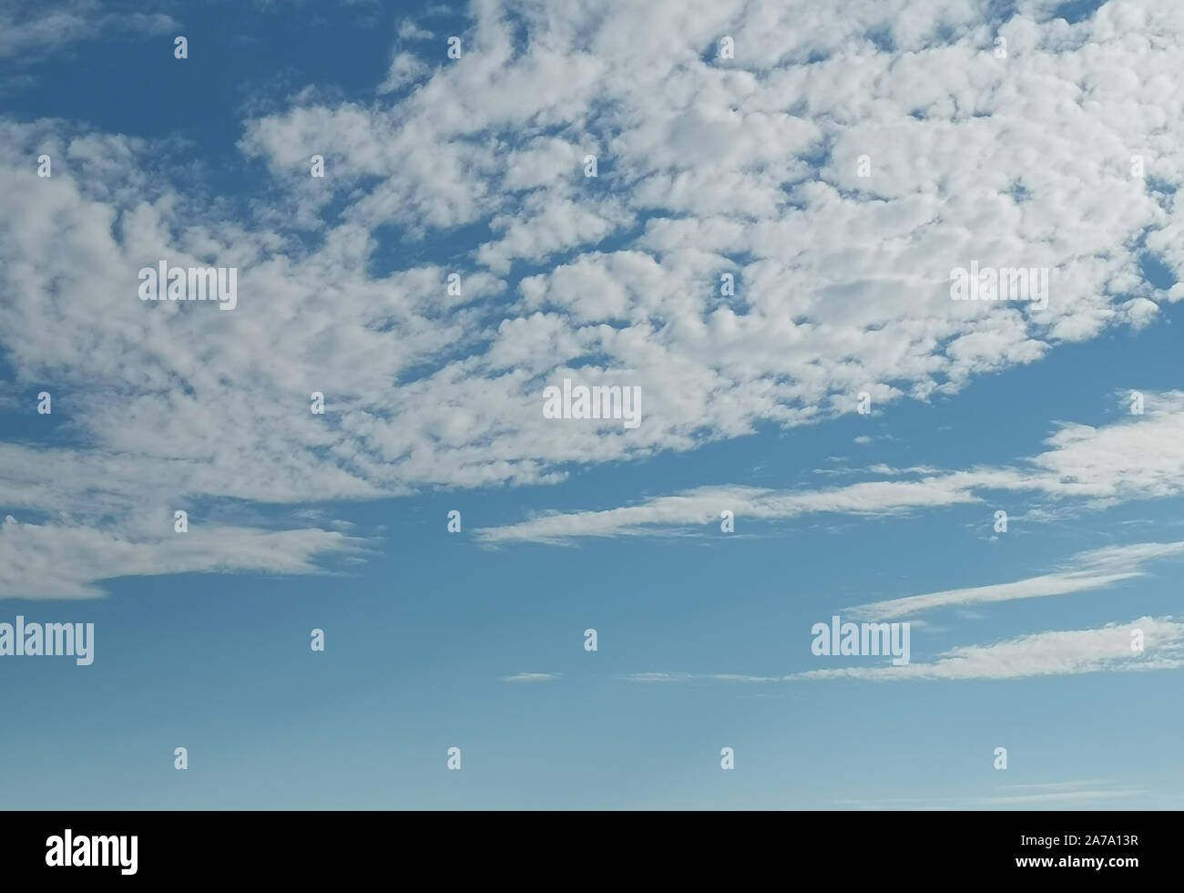Blue sky and white fluffy clouds. Background image Stock Photo - Alamy