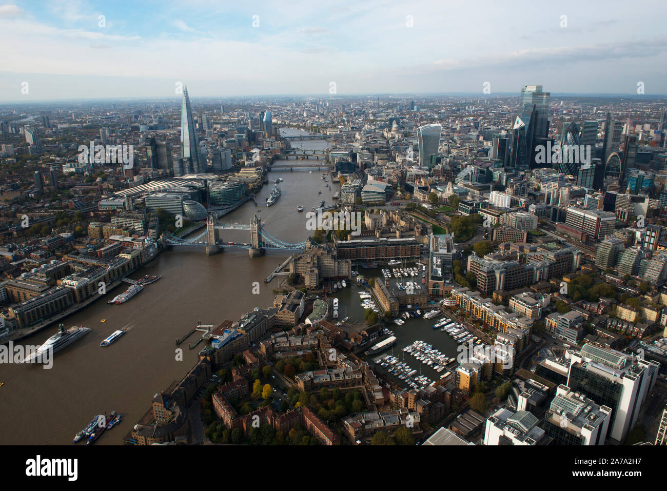 An aerial view of the City of London with Tower Bridge and St Katherines Dock in the foreground. Stock Photo