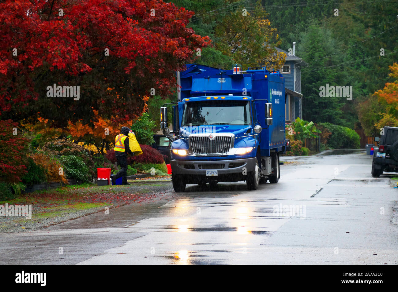 Blue Recycling Truck at Curbside. Maple Ridge, B. C., Canada. Stock Photo