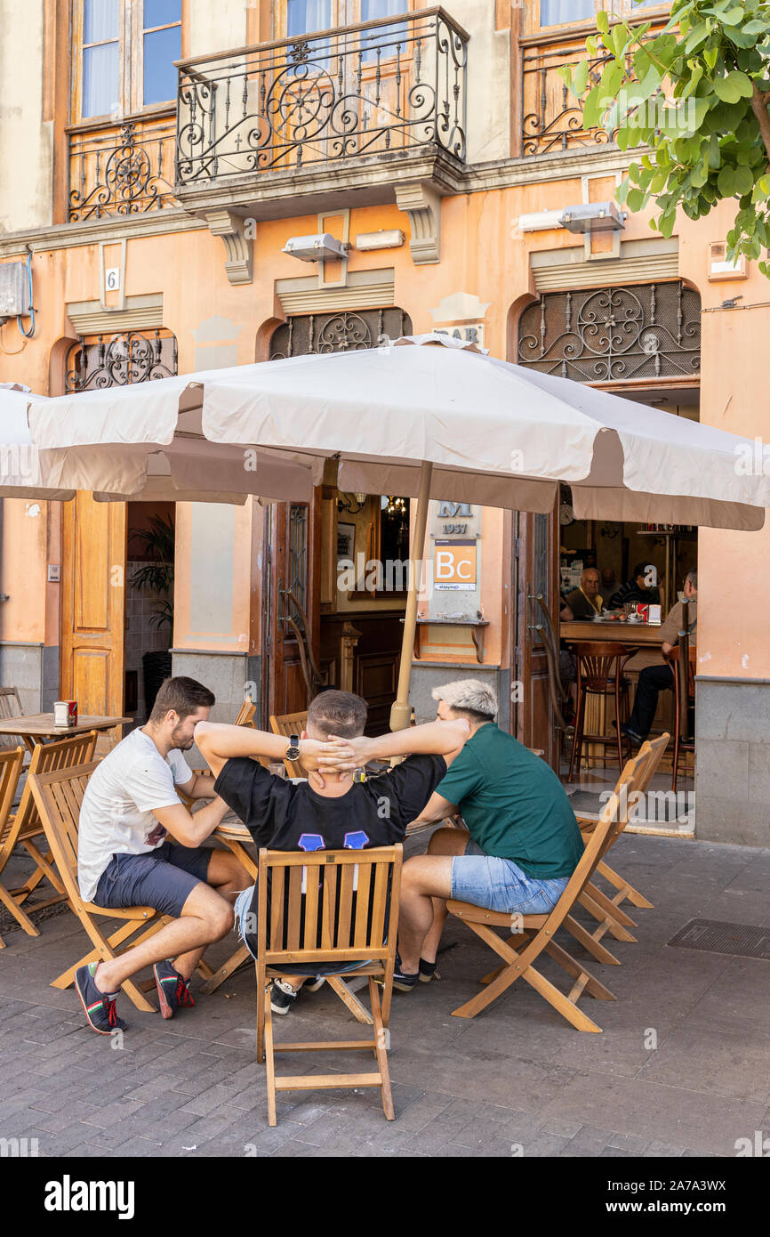 Group of young men at an outside table at a bar in San Cristobel de La Laguna, Tenerife, Canary Islands, Spain Stock Photo