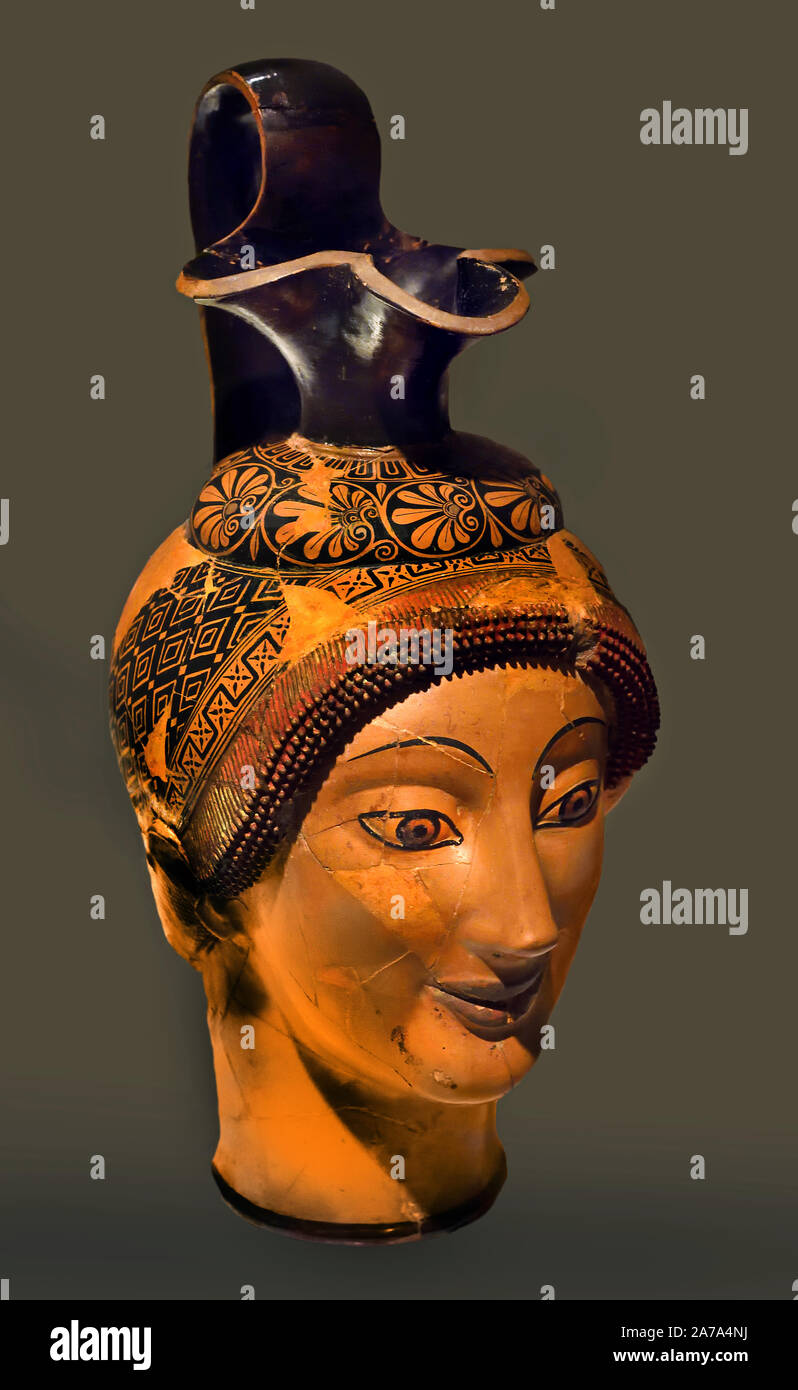 Oenochoe ( Wine Jug)  Form of a Woman's Head ( Hetaera head ? ) Created: Attica. late 6th century Greek Greece, ( The vase was created under the influence of late 6th-century BC monumental art. Charinos's skill makes this piece. ) found in a Etruscan tomb. Stock Photo