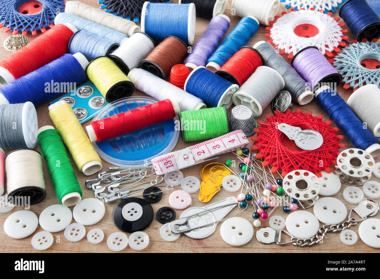 Sewing kit and sewing thread as one background Stock Photo