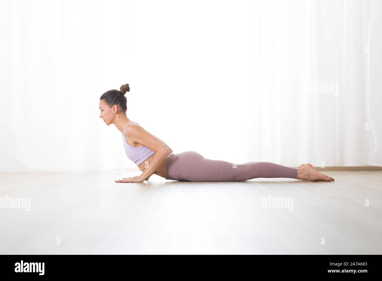 Portrait of gorgeous active sporty young woman practicing yoga in ...