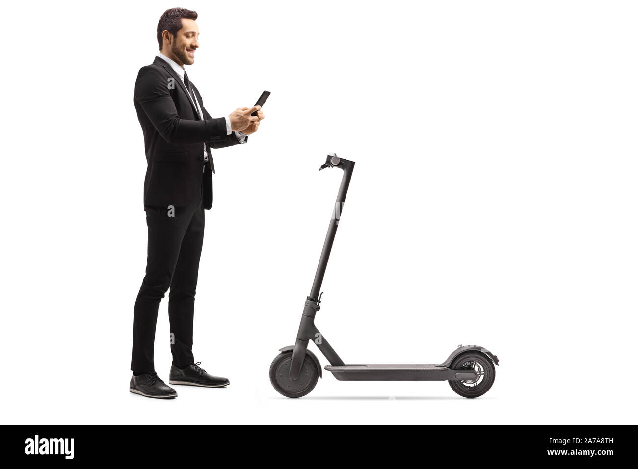 Full length shot of a businessman renting an electric scooter with a mobile phone application isolated on white background Stock Photo