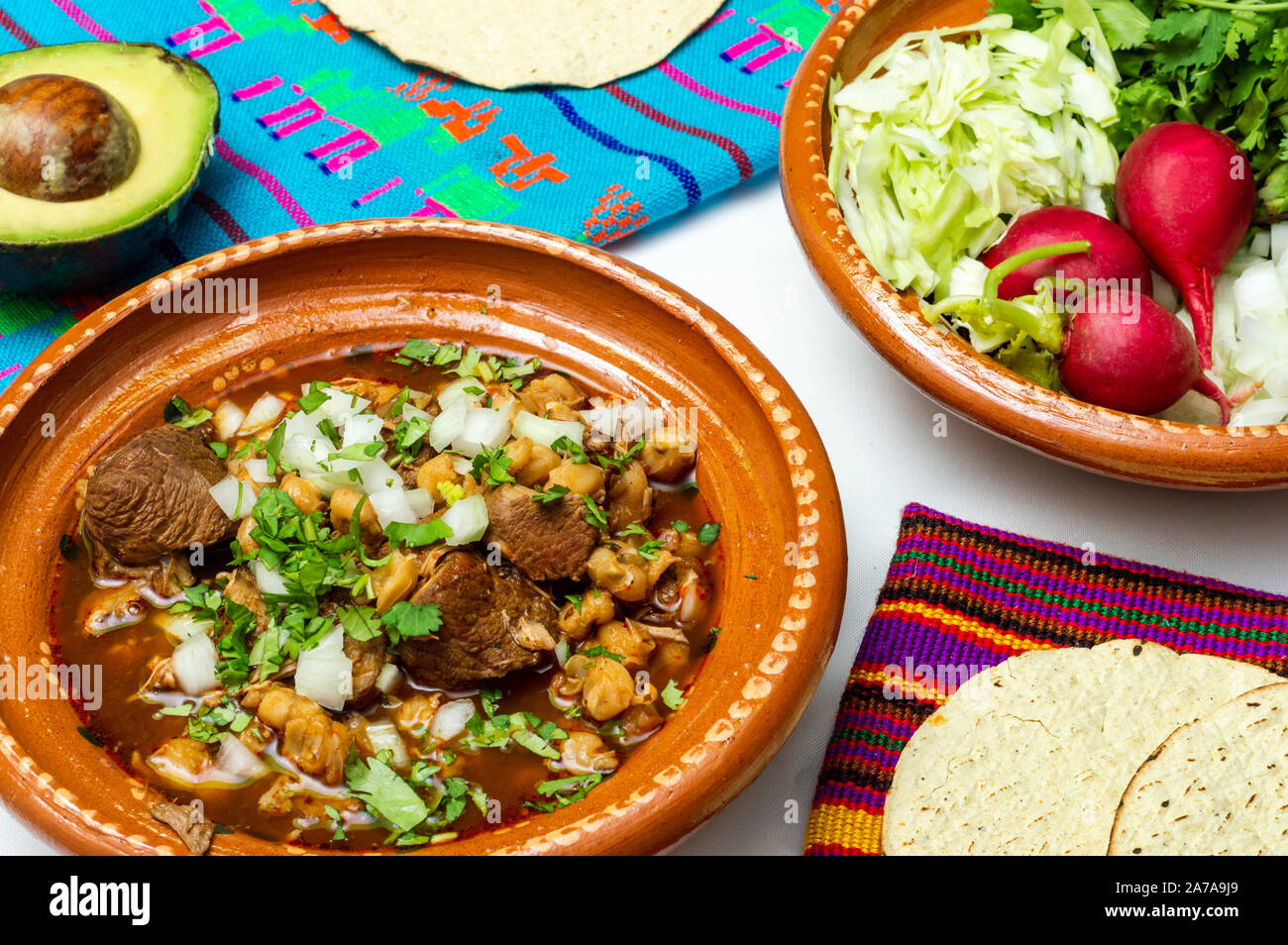 Red pozole, a traditional Mexican stew made with pork and hominy corn. In the Aztec heyday, this dish was made with human meat but the Spaniards ended Stock Photo