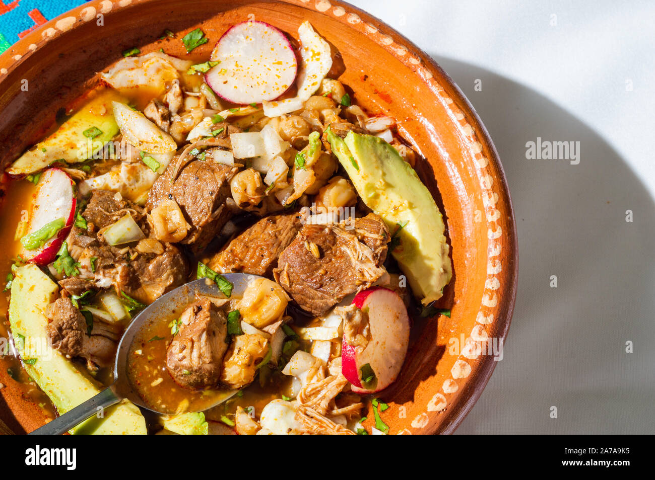 Red pozole, a traditional Mexican stew made with pork and hominy corn. In the Aztec heyday, this dish was made with human meat but the Spaniards ended Stock Photo