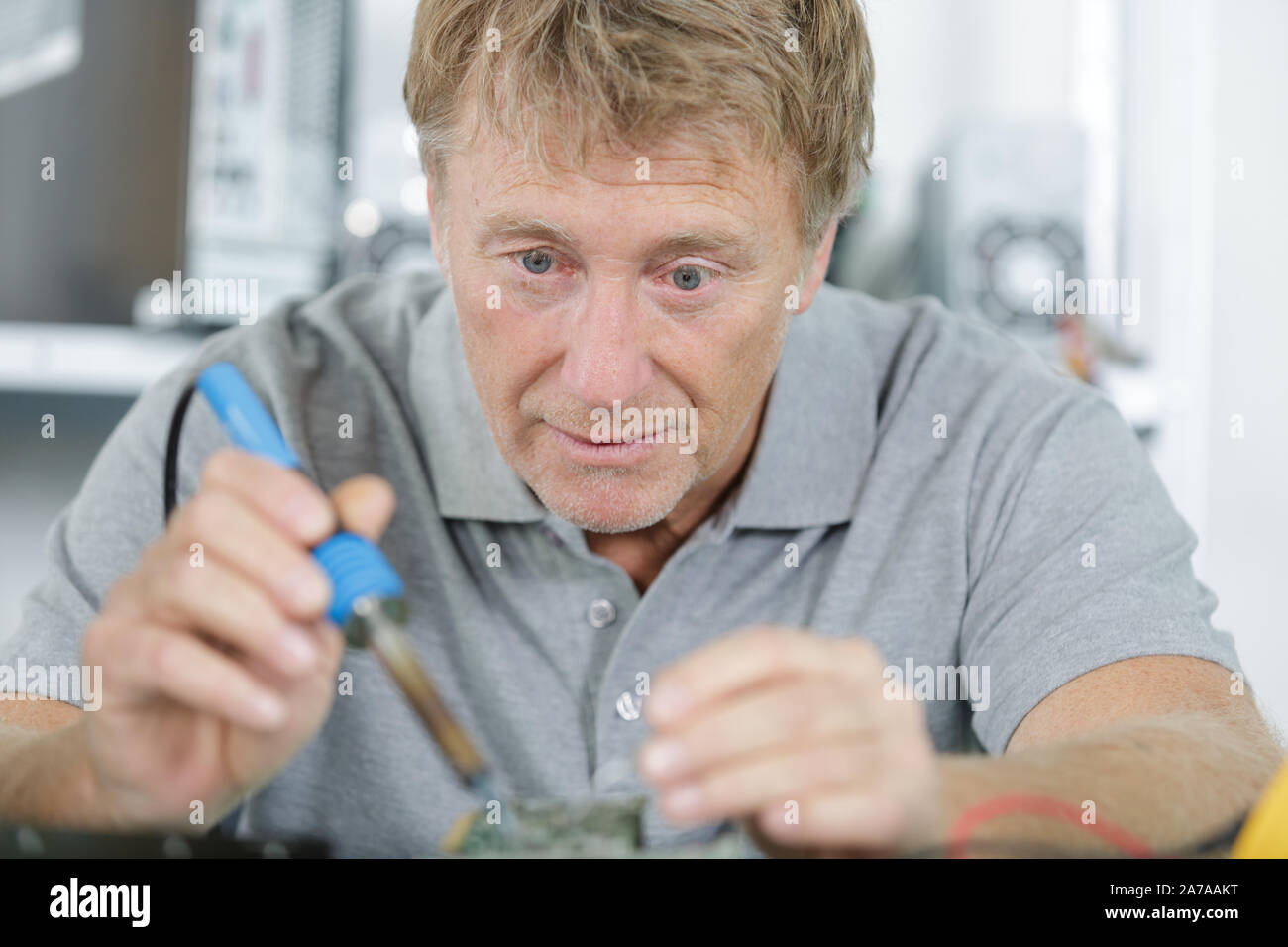 portrait of a man soldering electronic parts Stock Photo Alamy