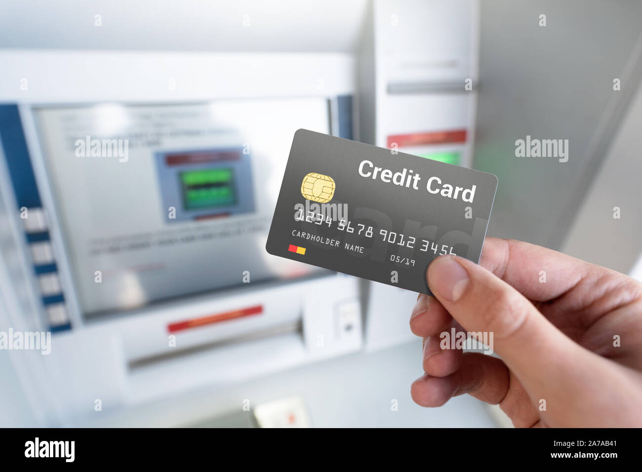 Withdraw money from an ATM using a credit card. Credit card close up. Stock Photo