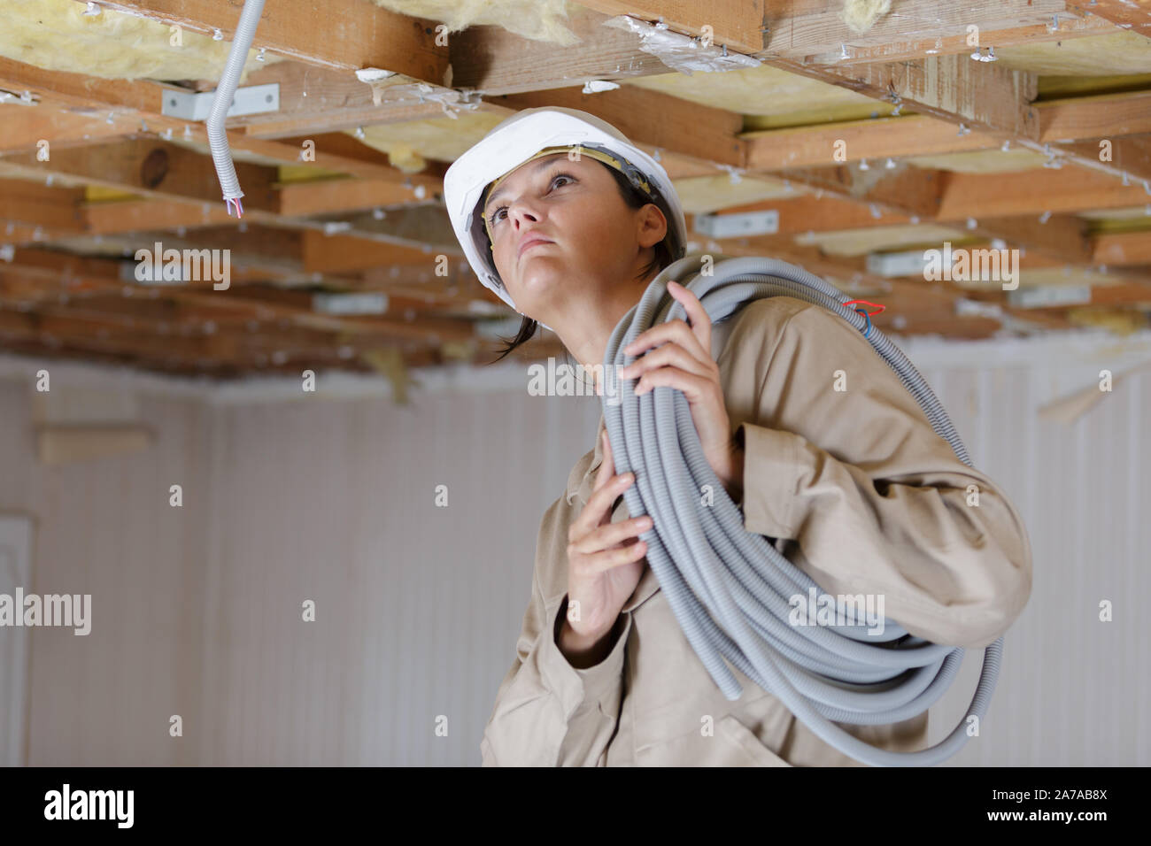female worker fitting ventilation pipes Stock Photo