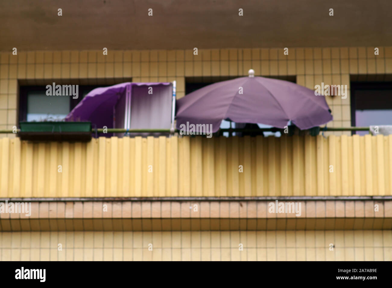 The balcony of a social housing with parasol. Stock Photo