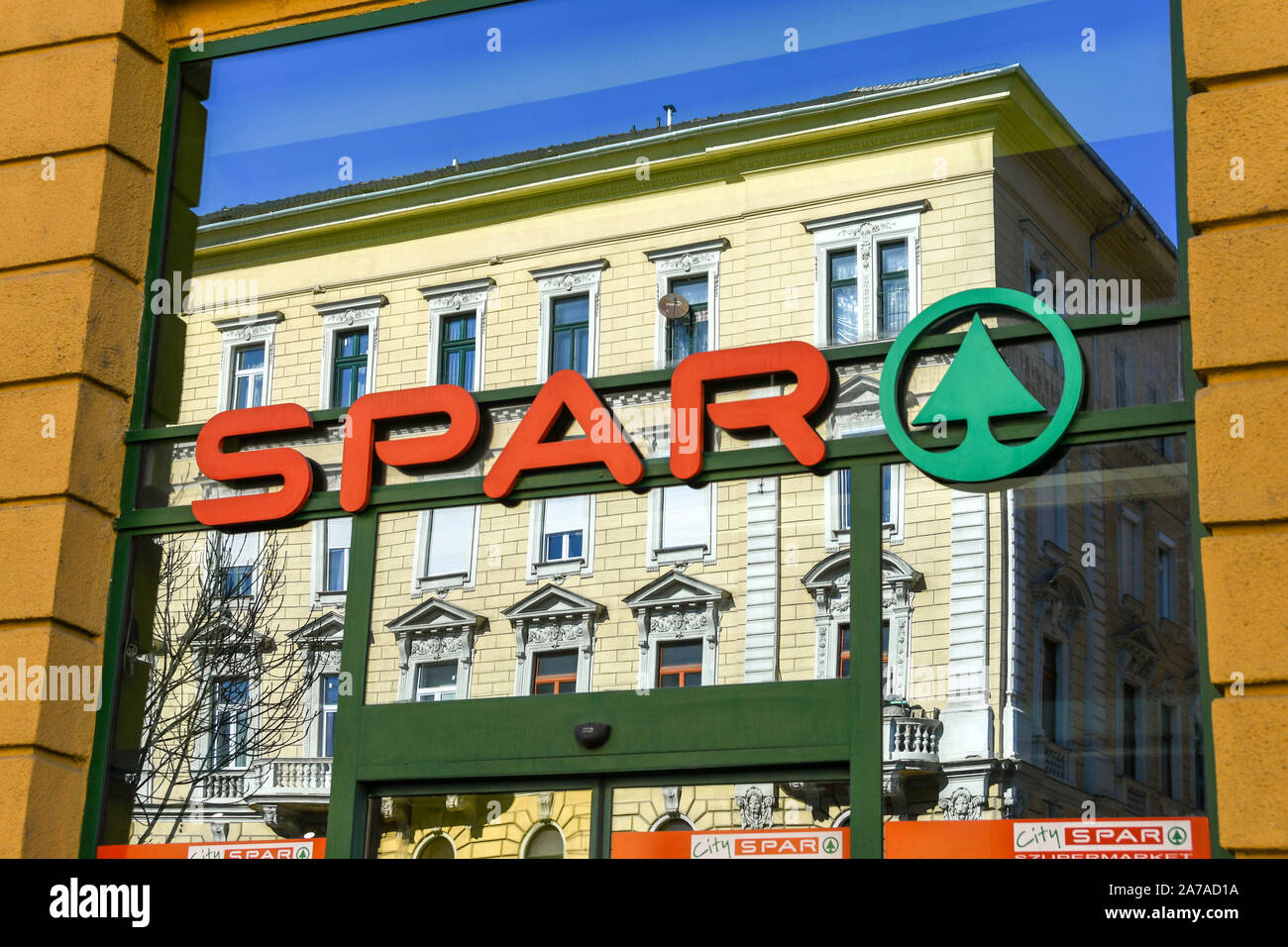 BUDAPEST, HUNGARY - MARCH 2019: Logo on the window of a Spar supermarket in Budapest with a reflection of the building opposite. Stock Photo
