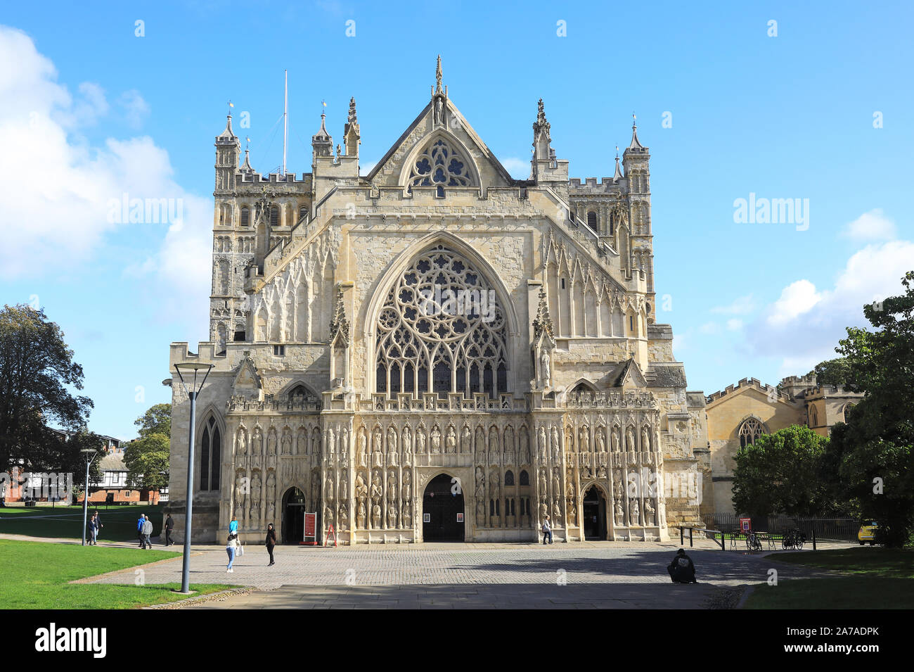 The medieval carvings of the West Front Image Screen of Exeter Cathedral on Cathedral Green in the autumn sunshine, in Devon, UK Stock Photo