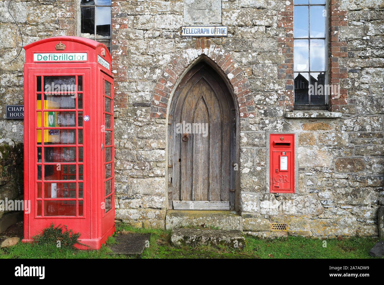 Old Telegraph Office, with K6 phone box defibrillator, in the village of Belstone, near Okehampton, UK Stock Photo