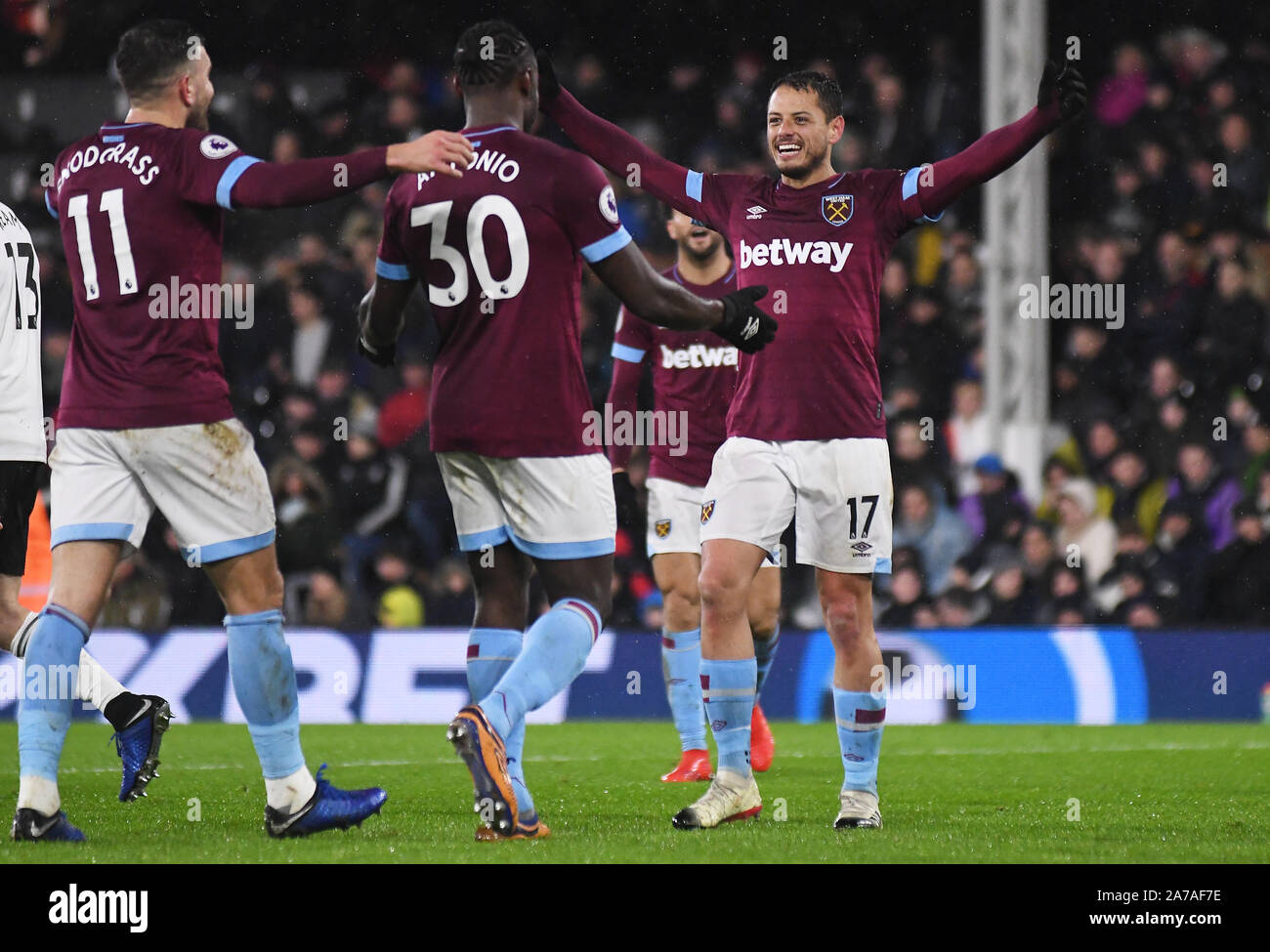 LONDON, ENGLAND - DECEMBER 15, 2018: Javier Hernandez Balcazar (Chicharito) of West Ham (R) celebrates with Michail Gregory Antonio of West Ham after he scored a goal during the 2018/19 Premier League game between Fulham FC and West Ham United at Craven Cottage. Stock Photo