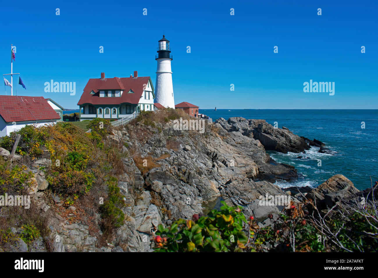 Red roofed Portland Head Lighthouse with a white light tower viewed from a rocky ledge in Fort Williams Park in Cape Elizabeth, Maine -02 Stock Photo