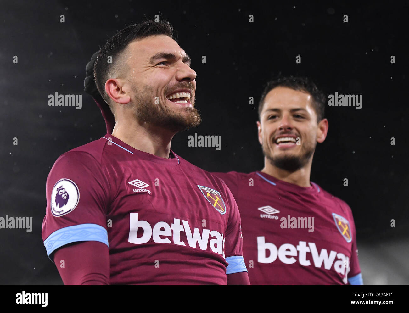 LONDON, ENGLAND - DECEMBER 15, 2018: Robert Snodgrass of West Ham celebrates with Javier Hernandez Balcazar (Chicharito) of West Ham after he scored a goal during the 2018/19 Premier League game between Fulham FC and West Ham United at Craven Cottage. Stock Photo